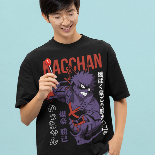 Happy man wearing a Kacchan Explosion Hero Tee in black with a lollipop in a kawaii style.