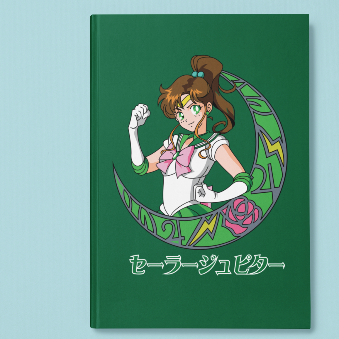 Sailor Jupiter Crescent Moon Journal in green against minimalist surface.