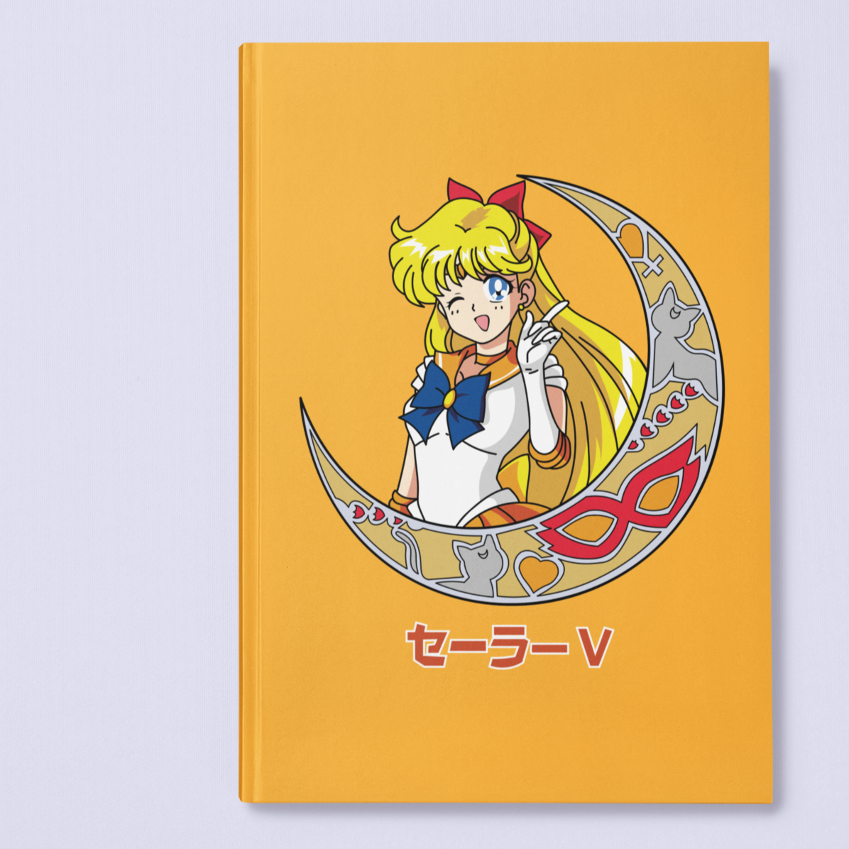 Sailor Venus Crescent Moon Journal in gold against minimalist surface.